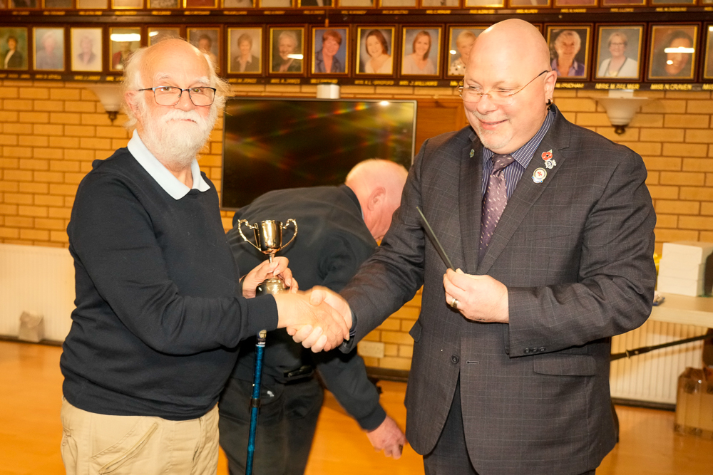 Peter Fry receiving the Clubman of the Year award from Rev Phil Denyer. 